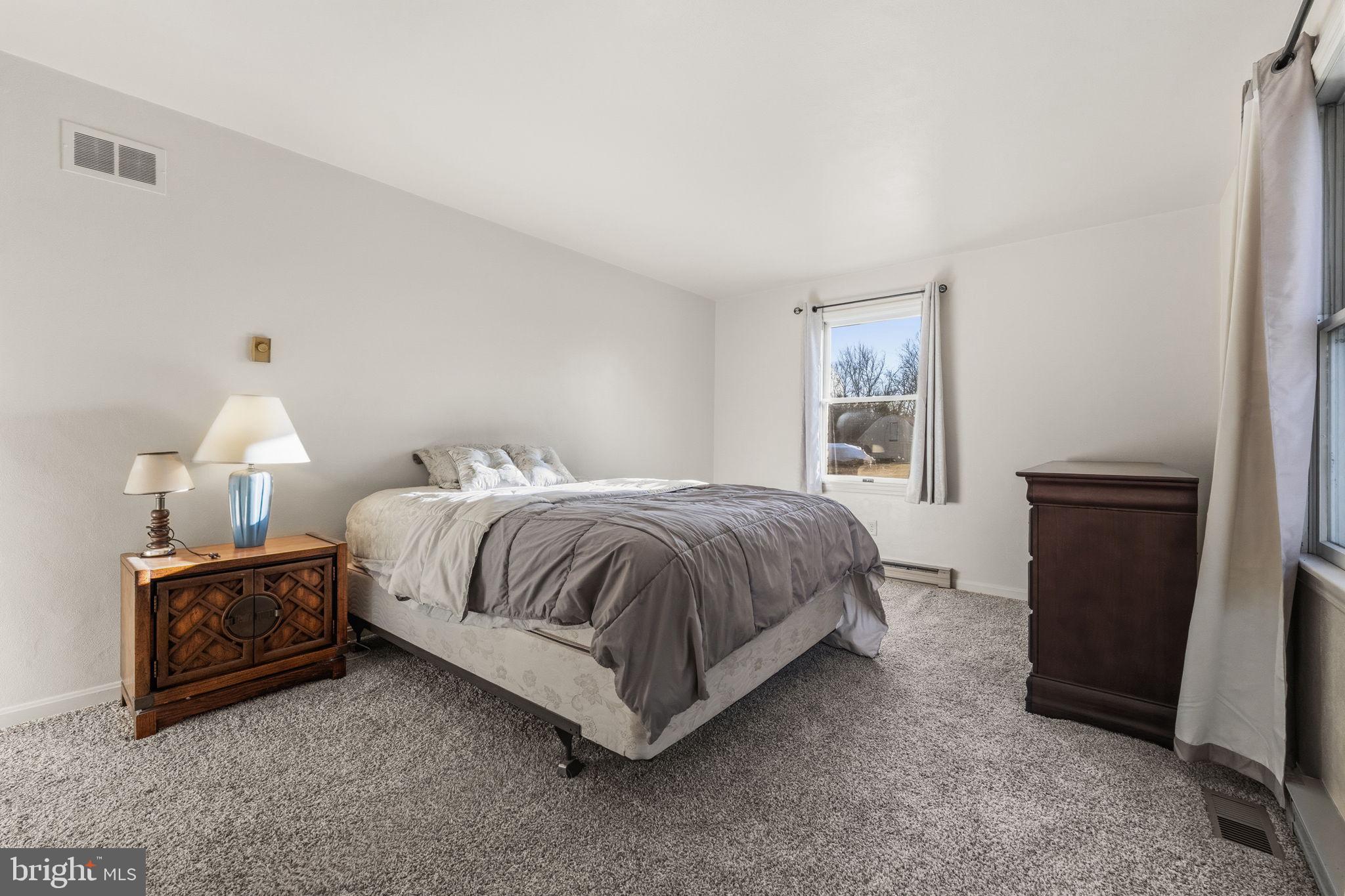 368 Appleton Road Elkton, MD 21921 - Photo 32 of 64 a spacious bedroom with a bed and a window