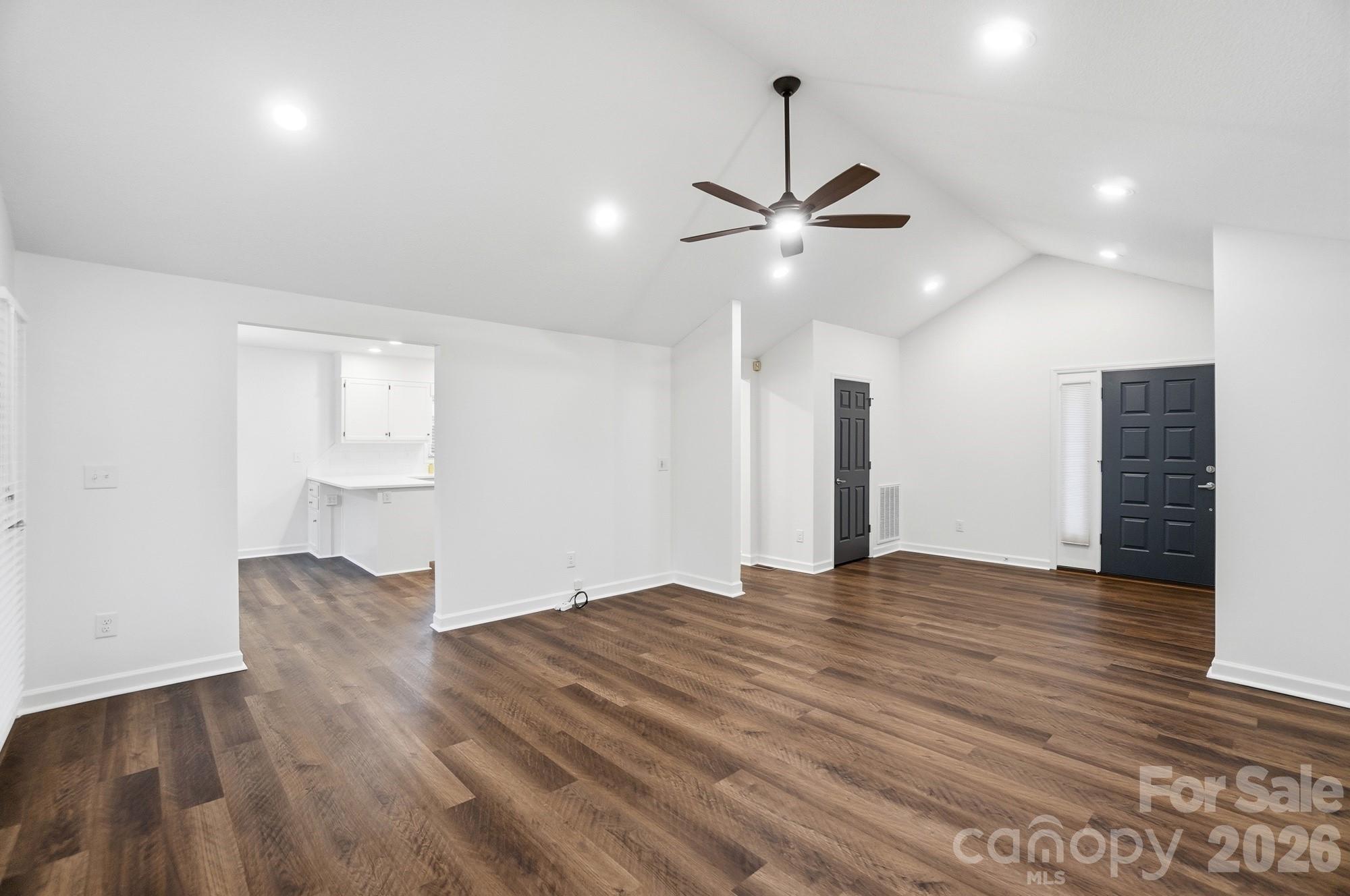 4437 Lake Shore Road North Denver, NC 28037 - Photo 13 of 43 a view of an empty room with wooden floor and a ceiling fan