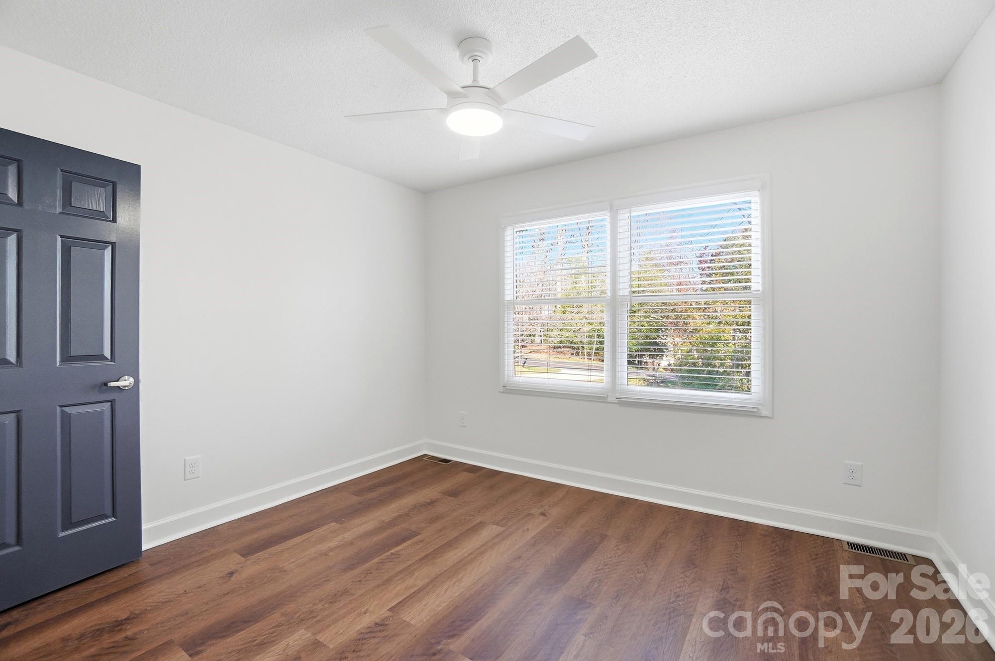 4437 Lake Shore Road North Denver, NC 28037 - Photo 18 of 43 an empty room with wooden floor and windows