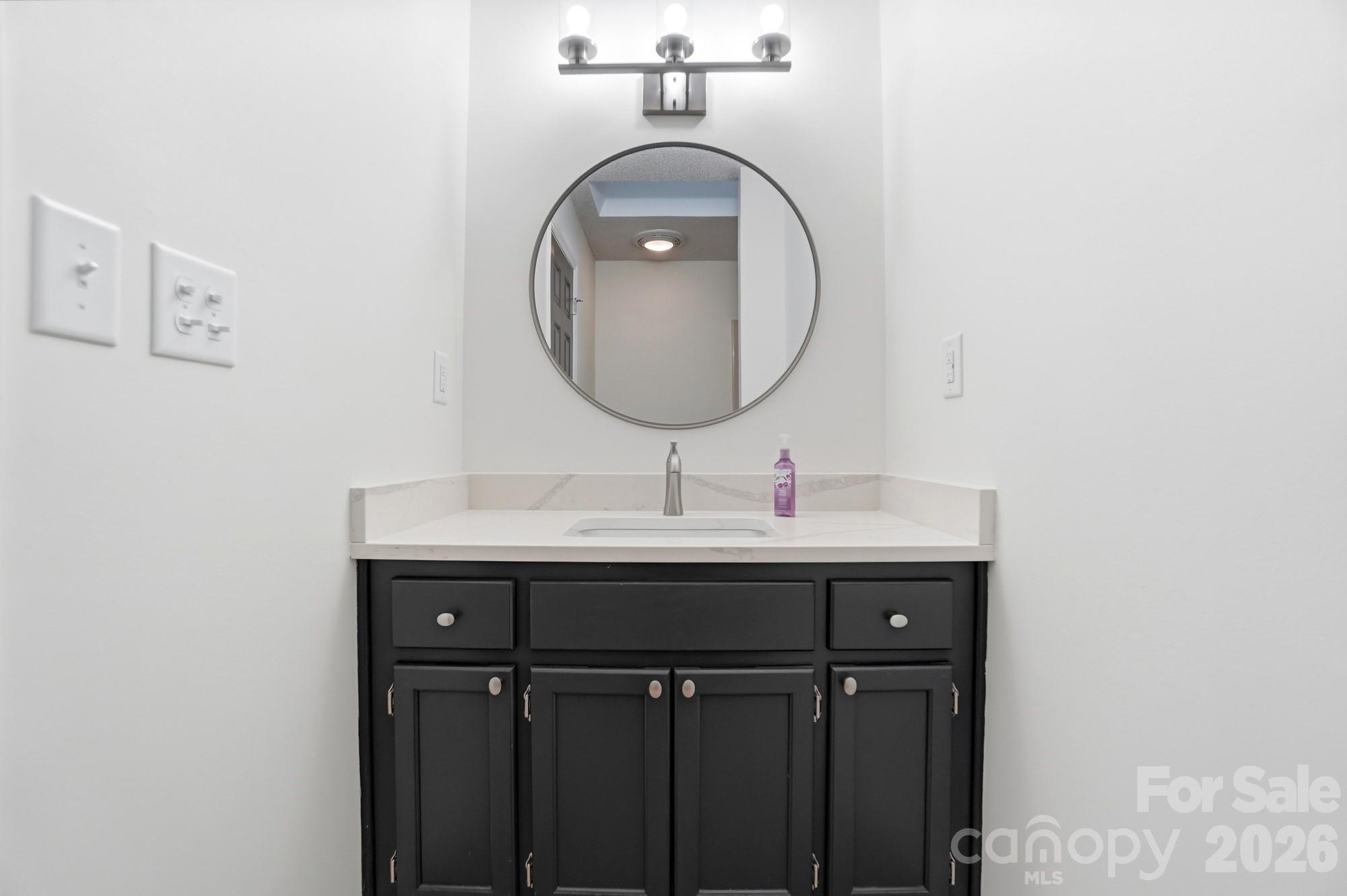4437 Lake Shore Road North Denver, NC 28037 - Photo 23 of 43 a bathroom with a sink and a mirror