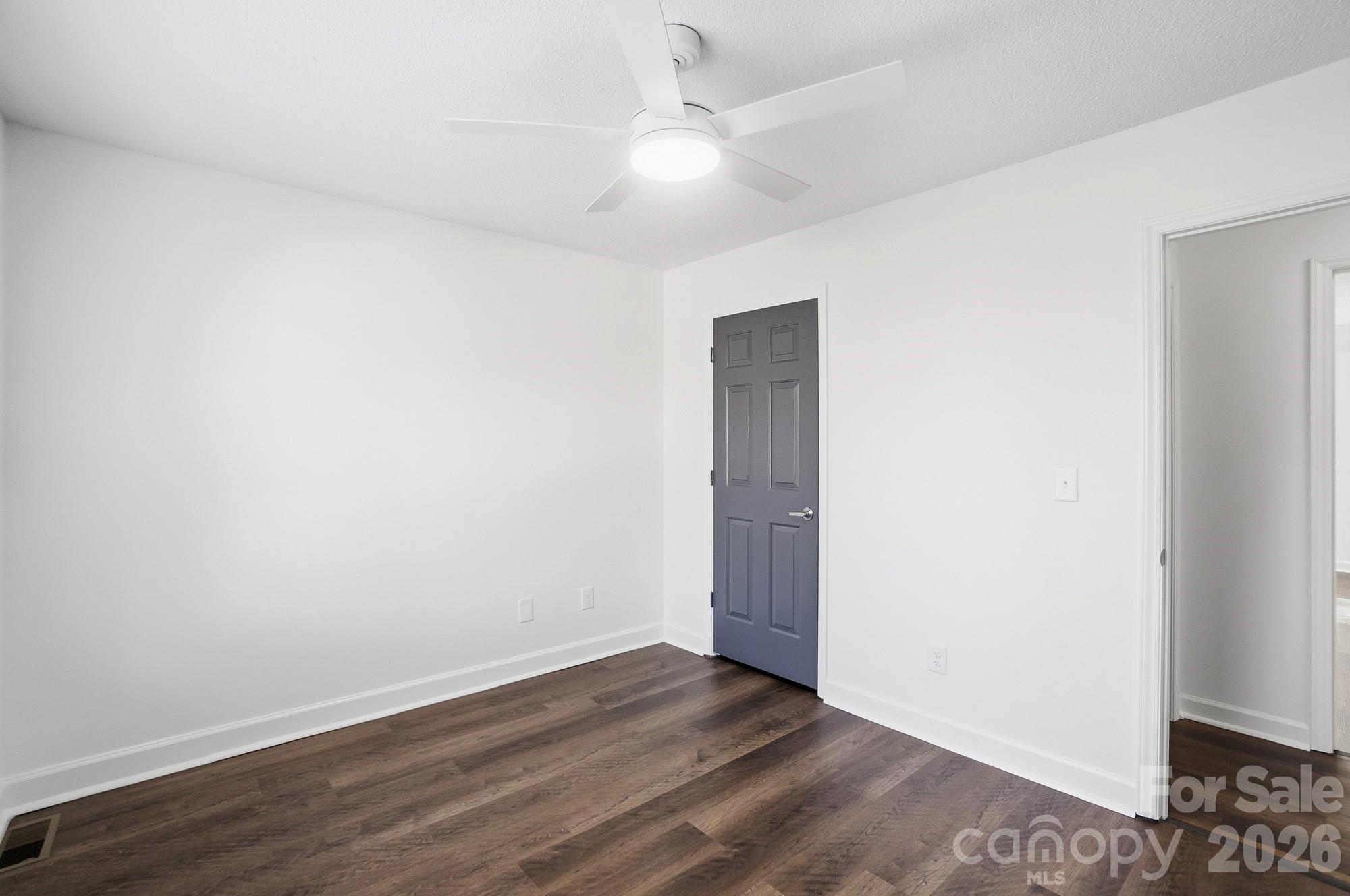 4437 Lake Shore Road North Denver, NC 28037 - Photo 25 of 43 an empty room with wooden floor and fan