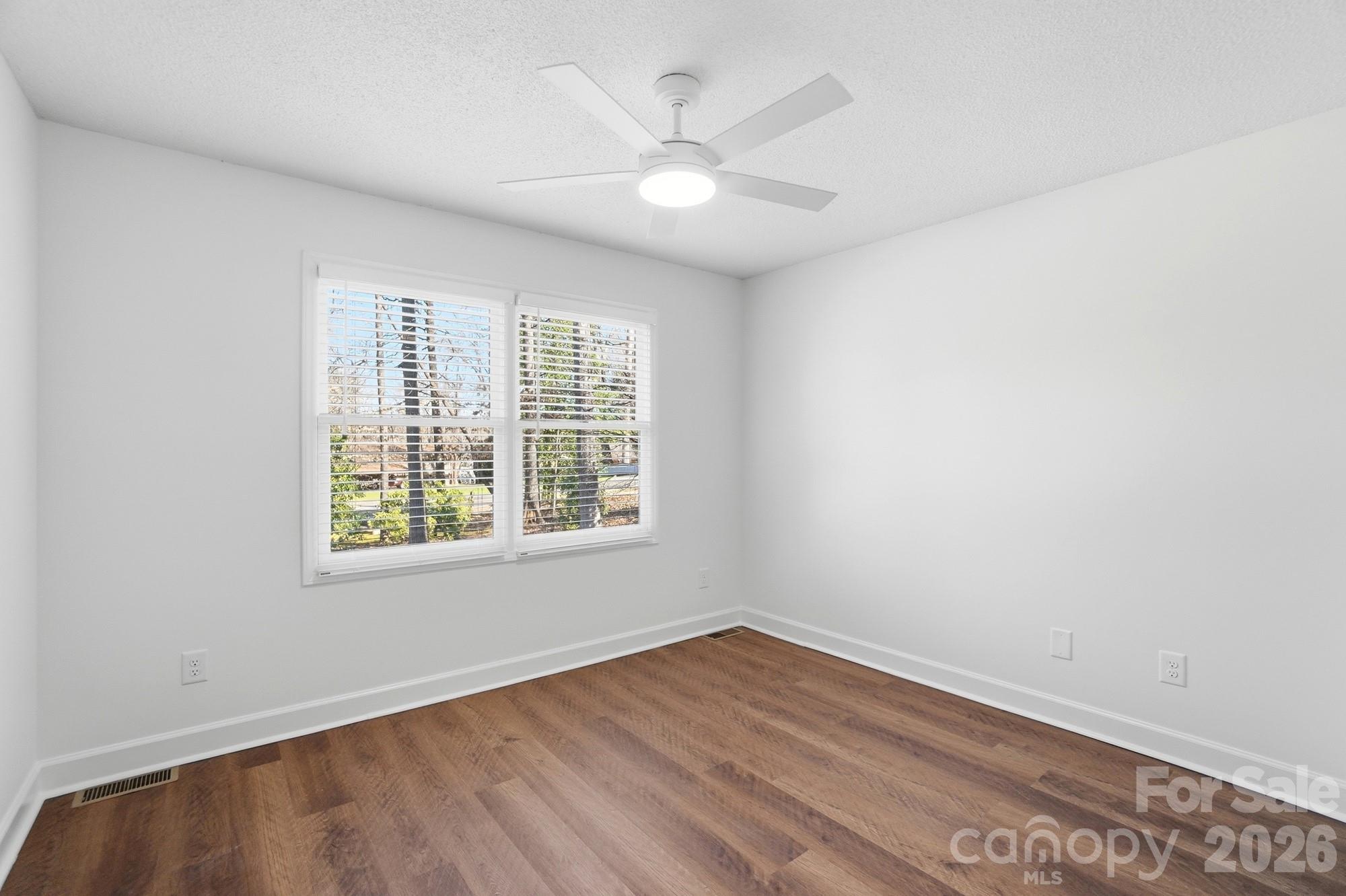 4437 Lake Shore Road North Denver, NC 28037 - Photo 26 of 43 an empty room with wooden floor and windows
