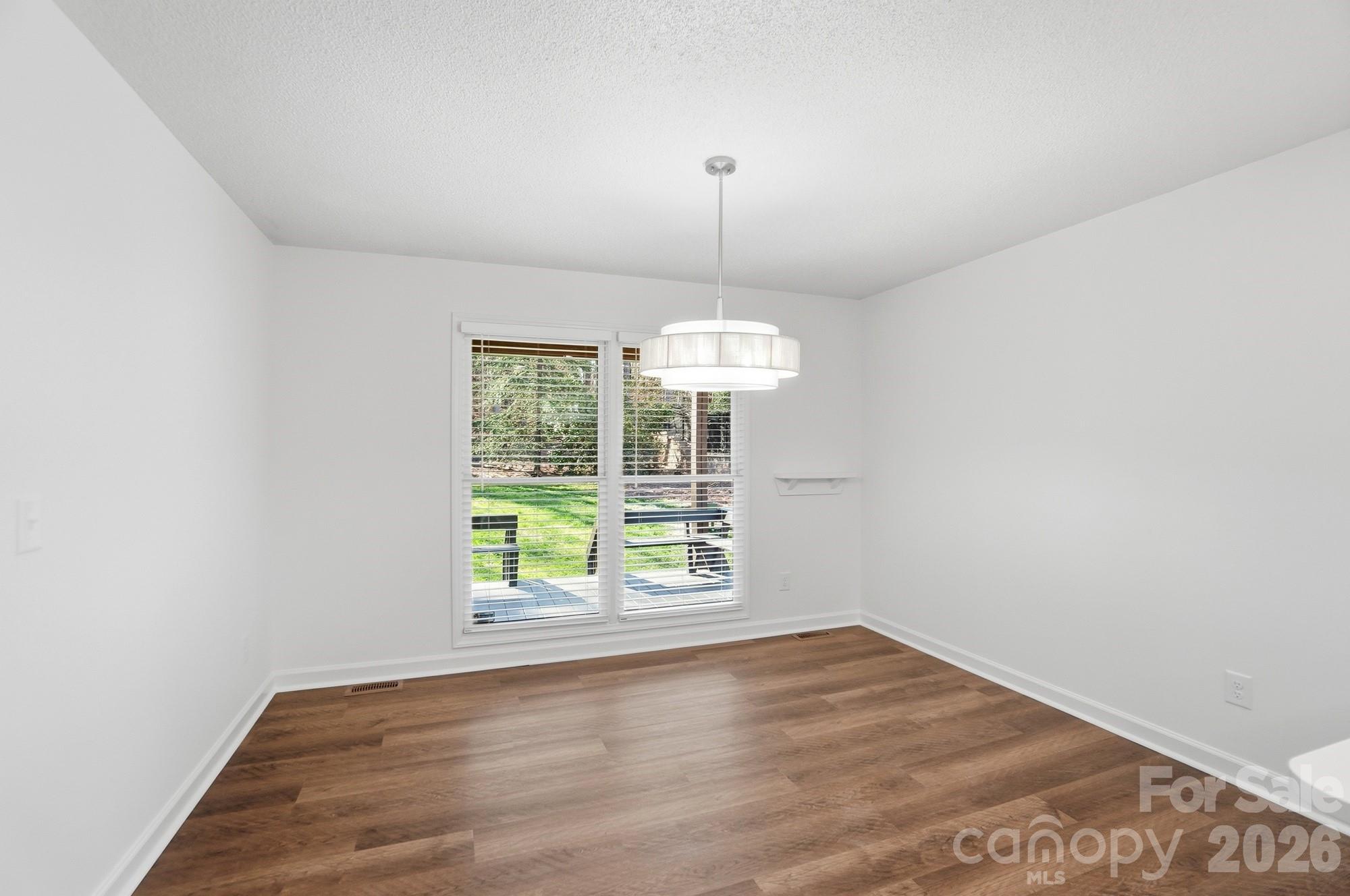 4437 Lake Shore Road North Denver, NC 28037 - Photo 29 of 43 an empty room with wooden floor and windows