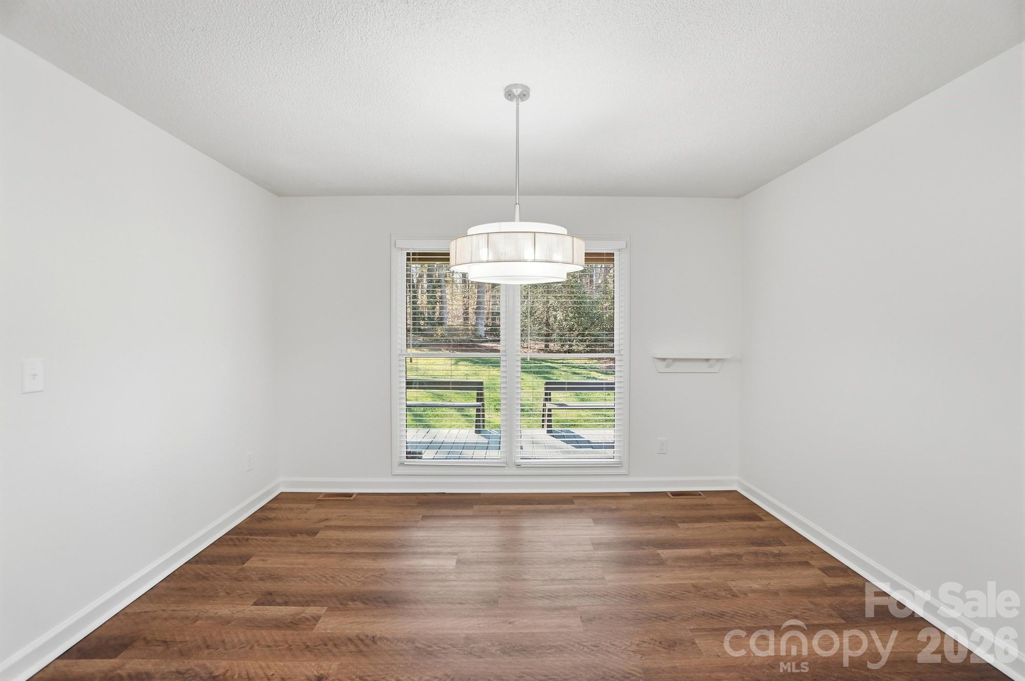 4437 Lake Shore Road North Denver, NC 28037 - Photo 32 of 43 a view of an empty room with wooden floor and a window