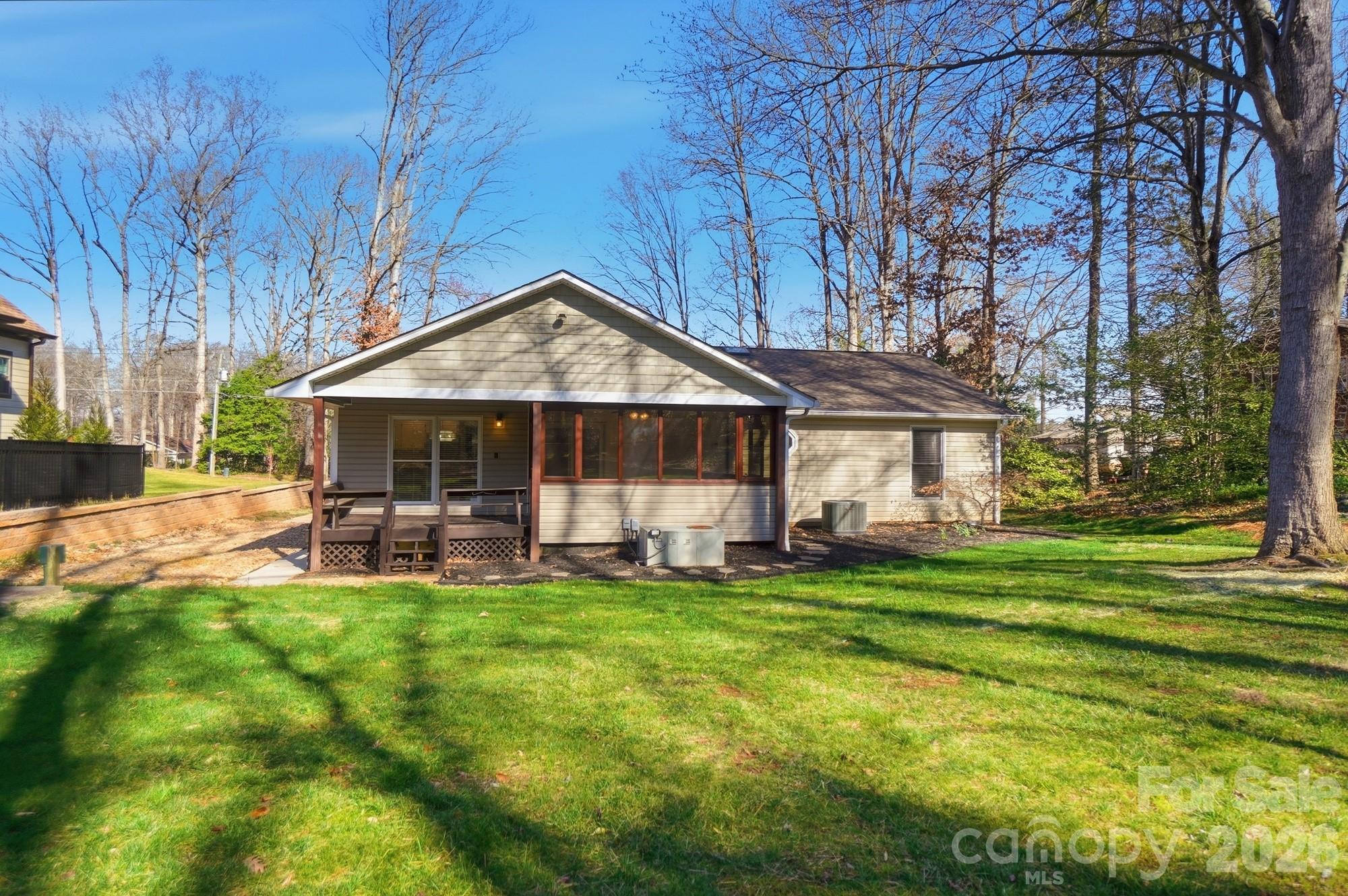 4437 Lake Shore Road North Denver, NC 28037 - Photo 42 of 43 a front view of a house with a garden and trees