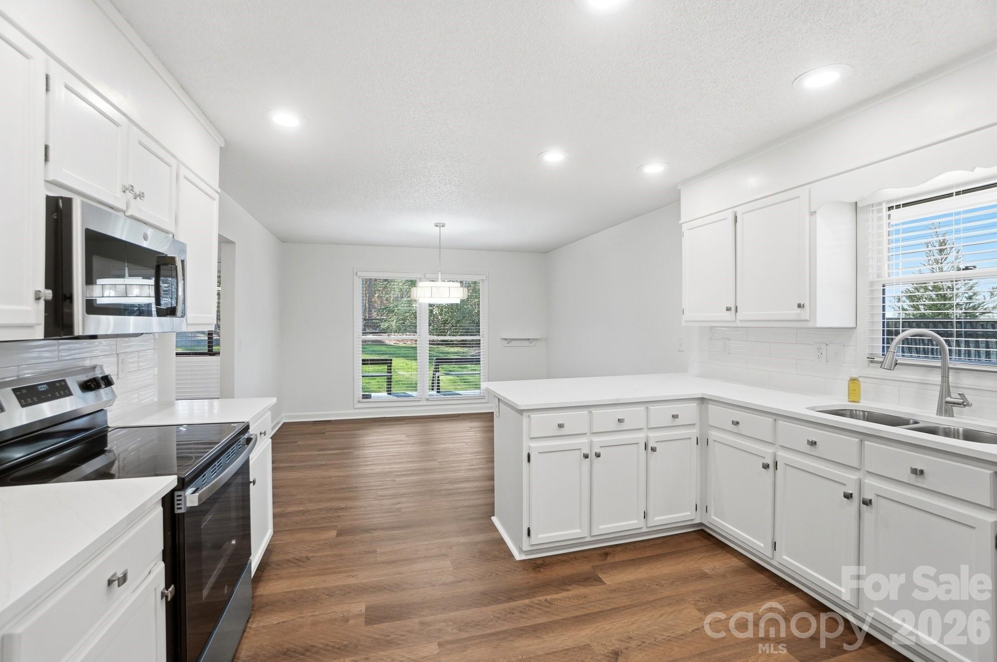 4437 Lake Shore Road North Denver, NC 28037 - Photo 5 of 43 a kitchen with a sink stove and cabinets