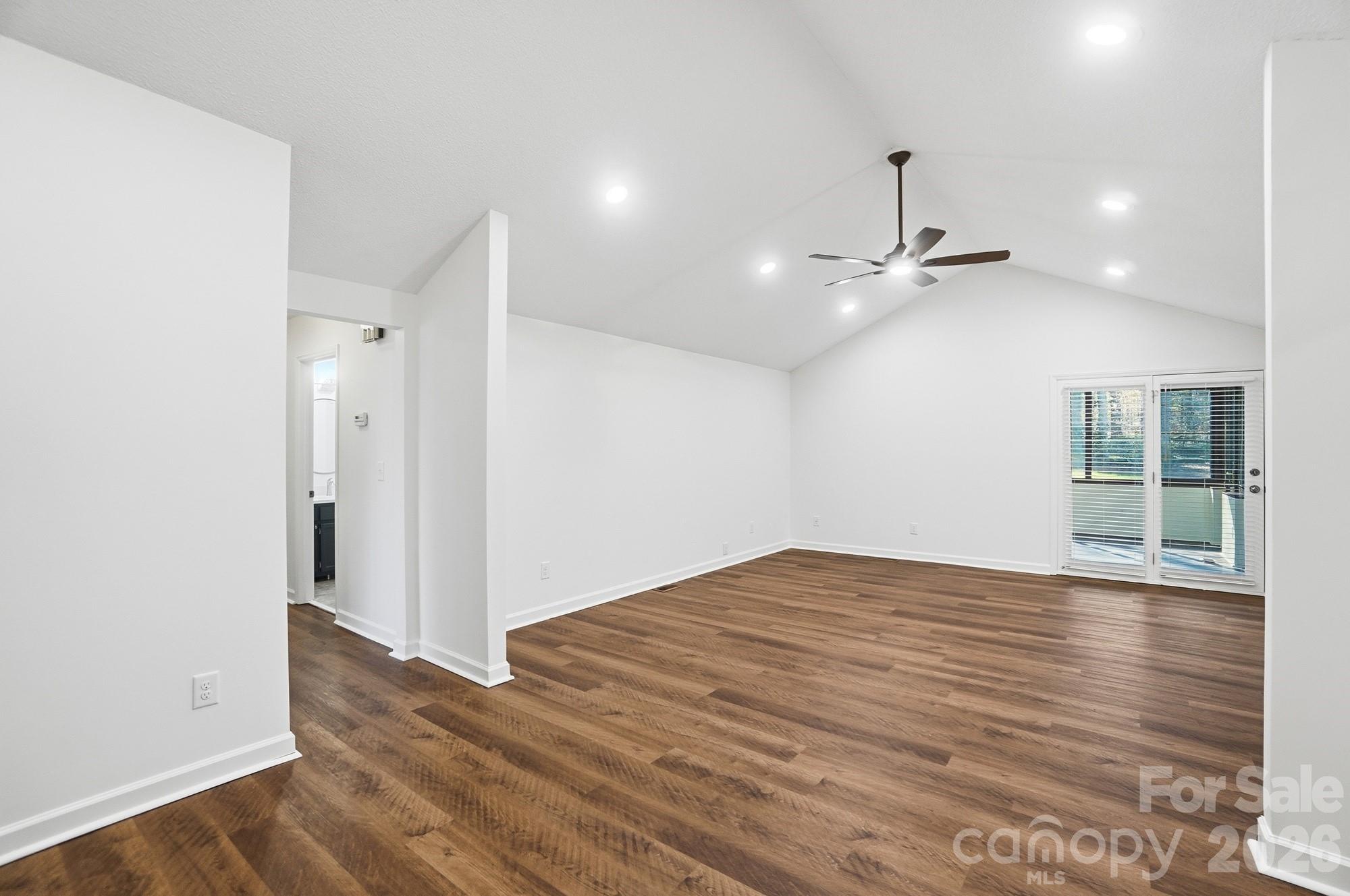 4437 Lake Shore Road North Denver, NC 28037 - Photo 6 of 43 a view of an empty room with a window and wooden floor
