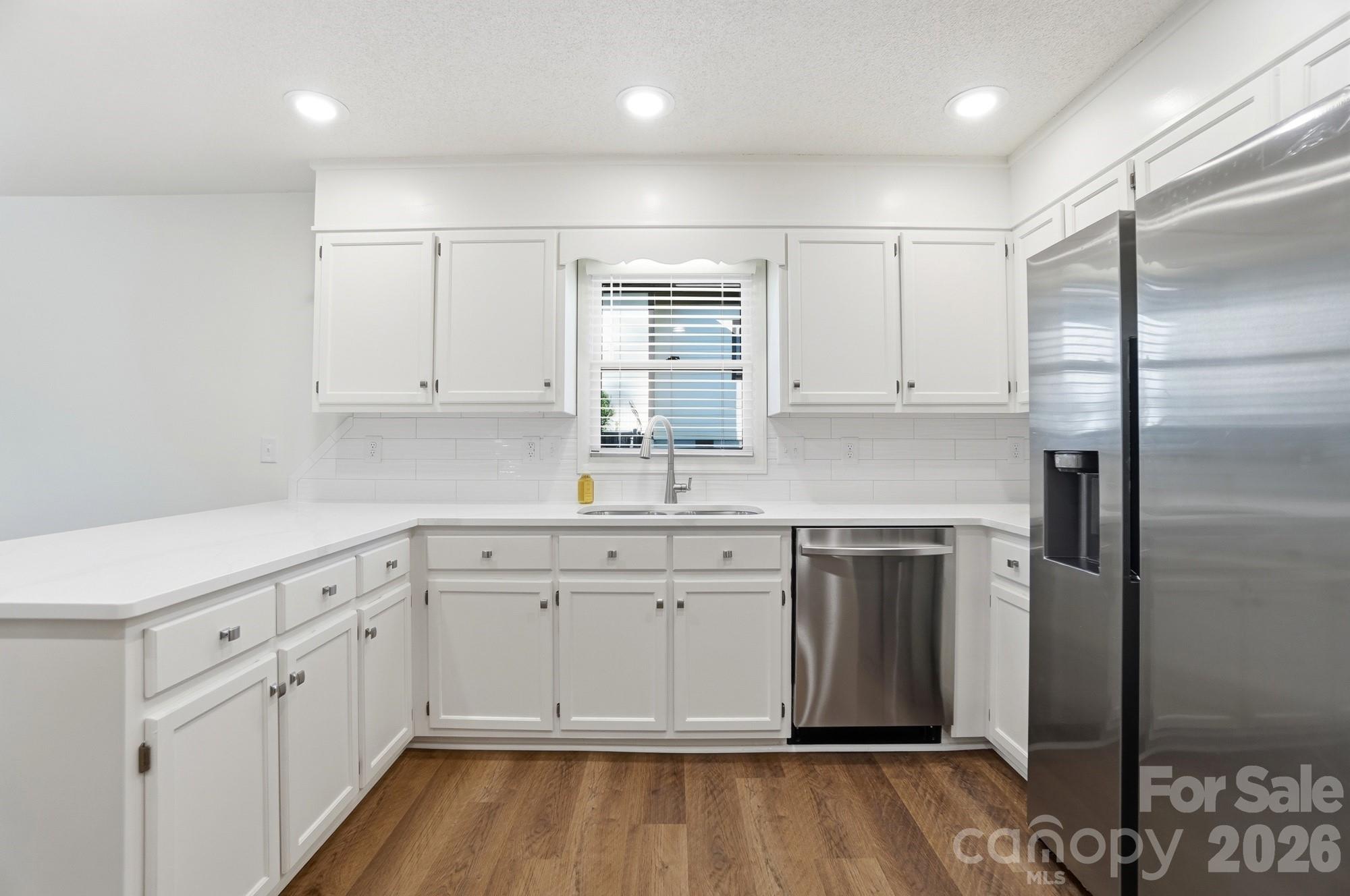 4437 Lake Shore Road North Denver, NC 28037 - Photo 7 of 43 a kitchen with white cabinets stainless steel appliances and a refrigerator