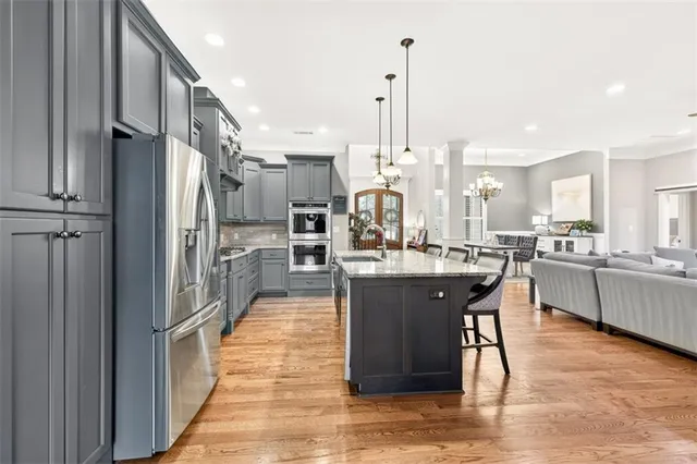 a large kitchen with a table and chairs