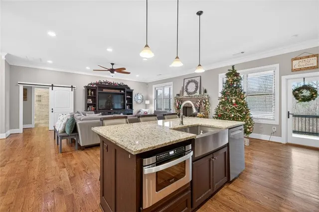 a kitchen with a stove and a wooden floor