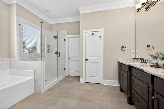 a spacious bathroom with a tub sink shower and mirror