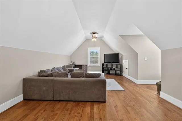 a living room with stainless steel appliances granite countertop lots of counter top space and a ceiling fan