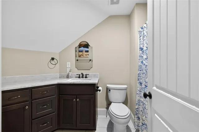 a kitchen with stainless steel appliances granite countertop a dining table chairs refrigerator and cabinets