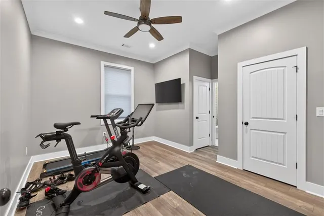 a spacious bathroom with a granite countertop sink a toilet a mirror a shower and bathtub