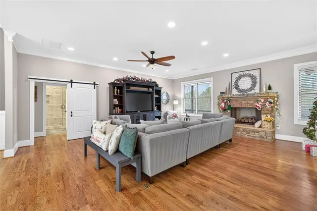 a living room with furniture a flat screen tv and a fireplace