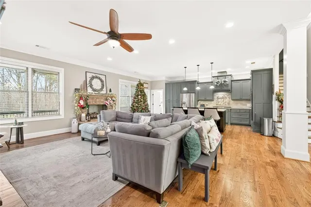 a living room with furniture a fireplace and a flat screen tv