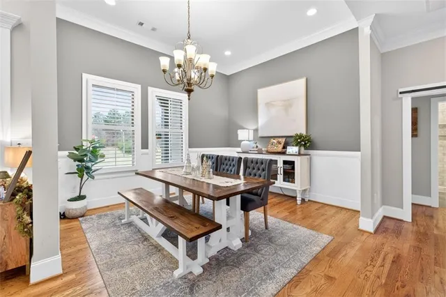 a living room with furniture a dining table and a chandelier