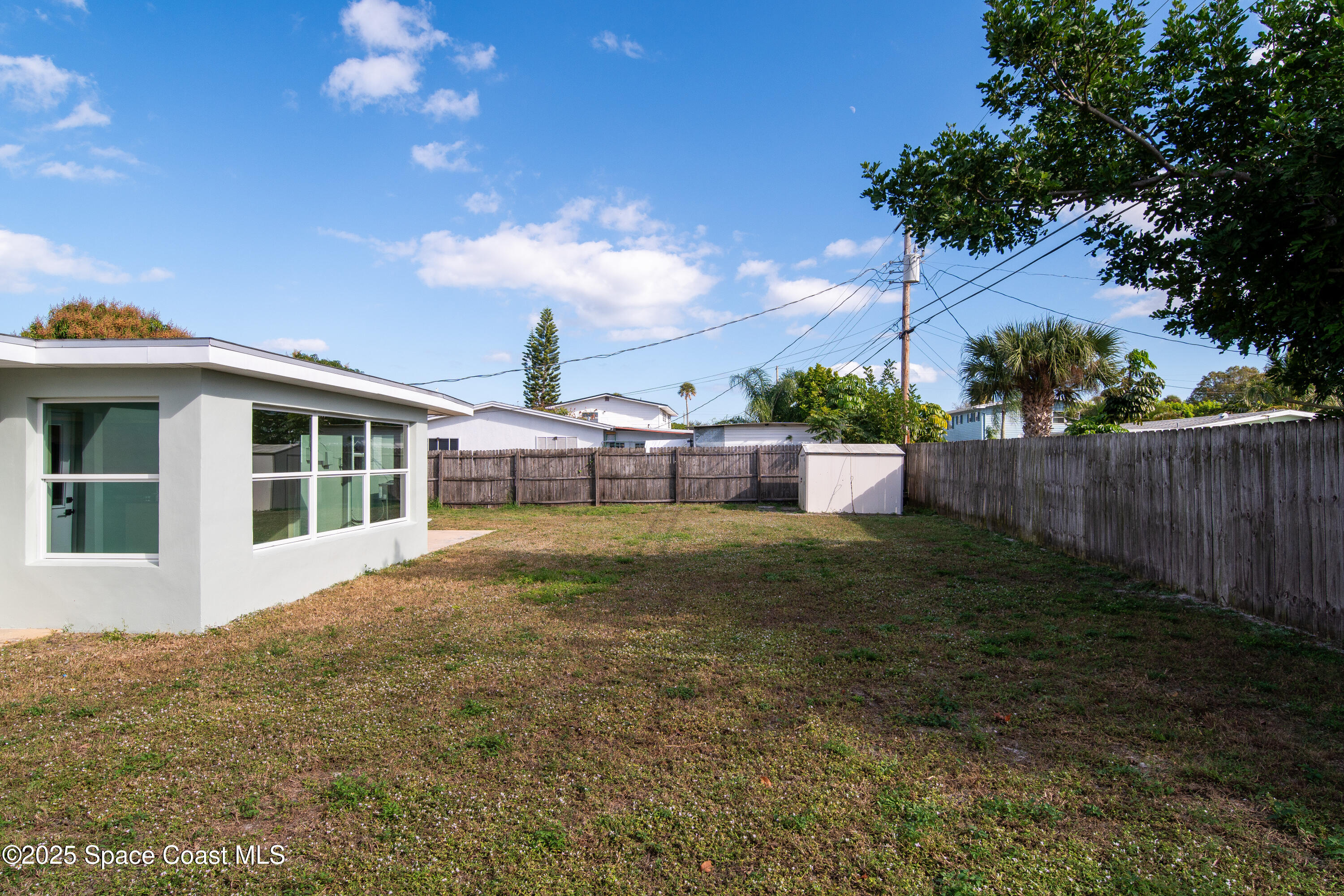 1705 Sarno Acc Melbourne, FL 32935 - Photo 14 of 40 a view of a house with backyard and garden