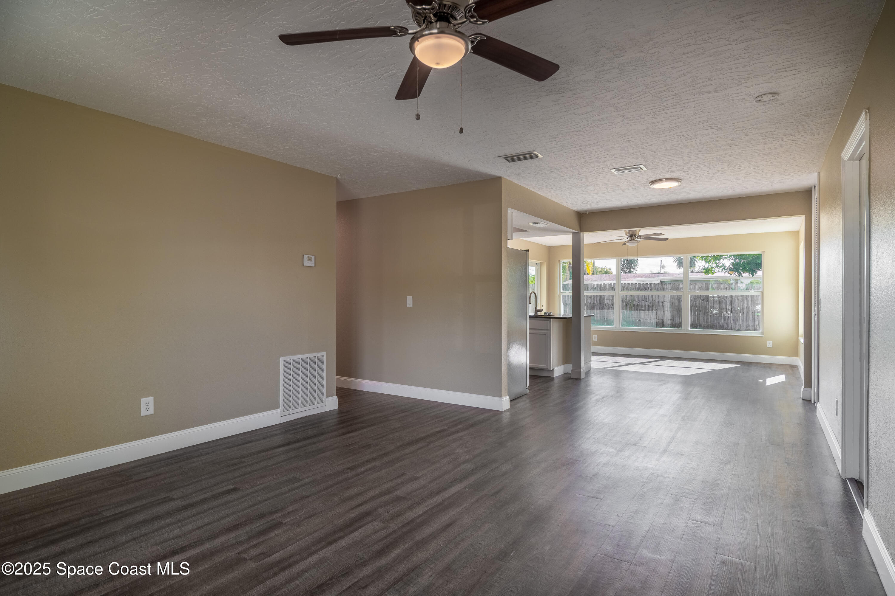 1705 Sarno Acc Melbourne, FL 32935 - Photo 16 of 40 wooden floor in an empty room with a window