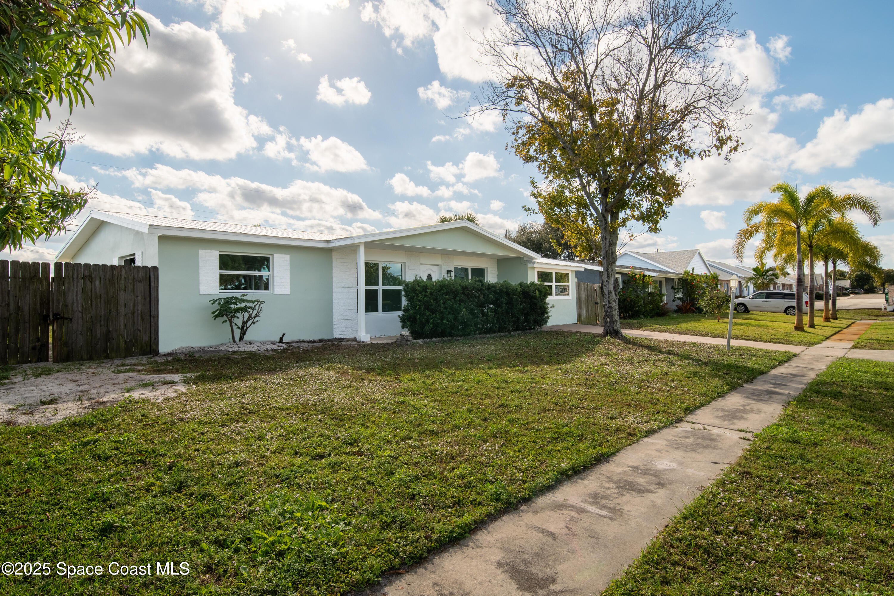 1705 Sarno Acc Melbourne, FL 32935 - Photo 2 of 40 a view of a house with backyard and trees