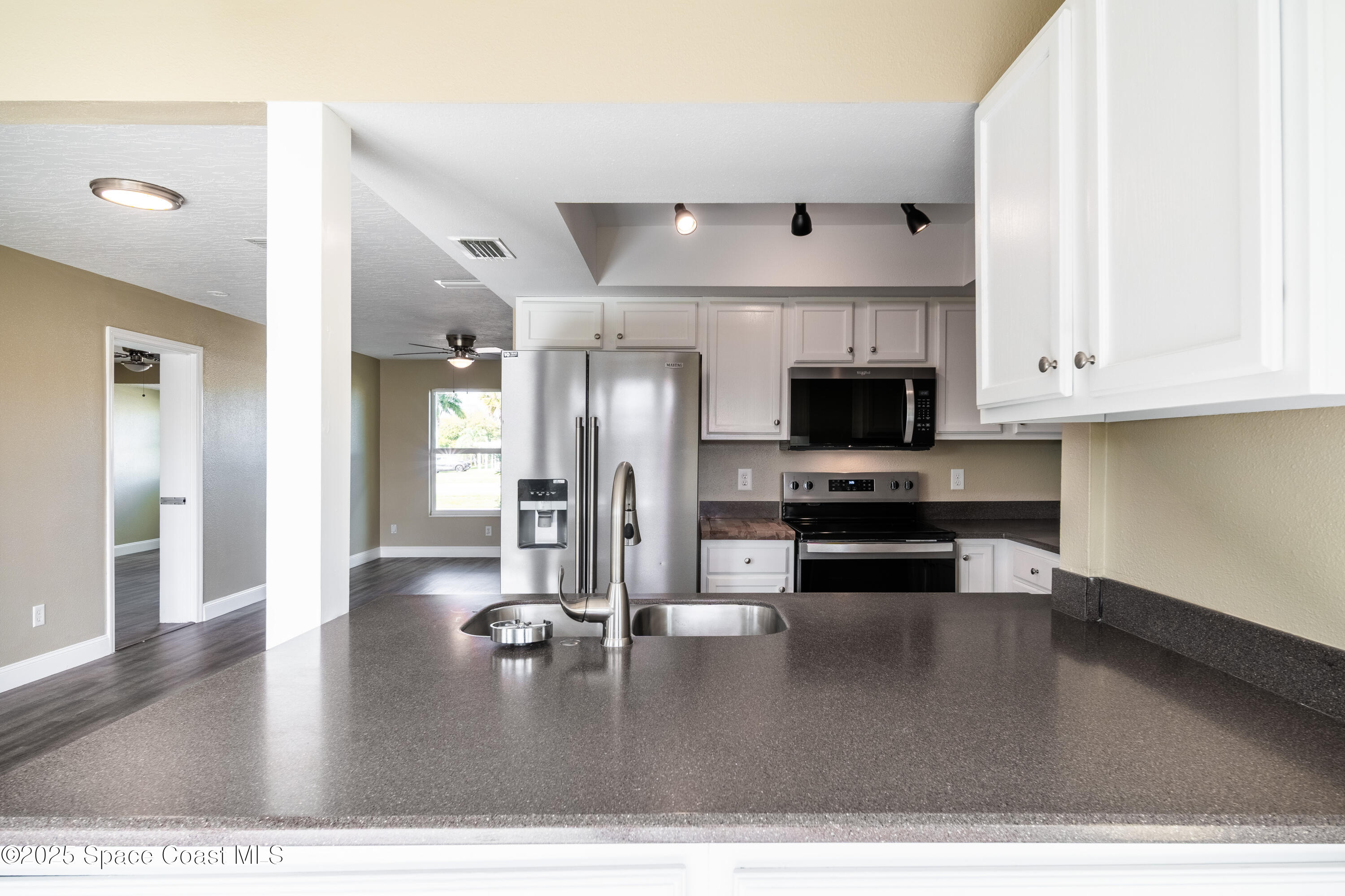 1705 Sarno Acc Melbourne, FL 32935 - Photo 32 of 40 a kitchen with stainless steel appliances granite countertop a refrigerator a stove and a sink