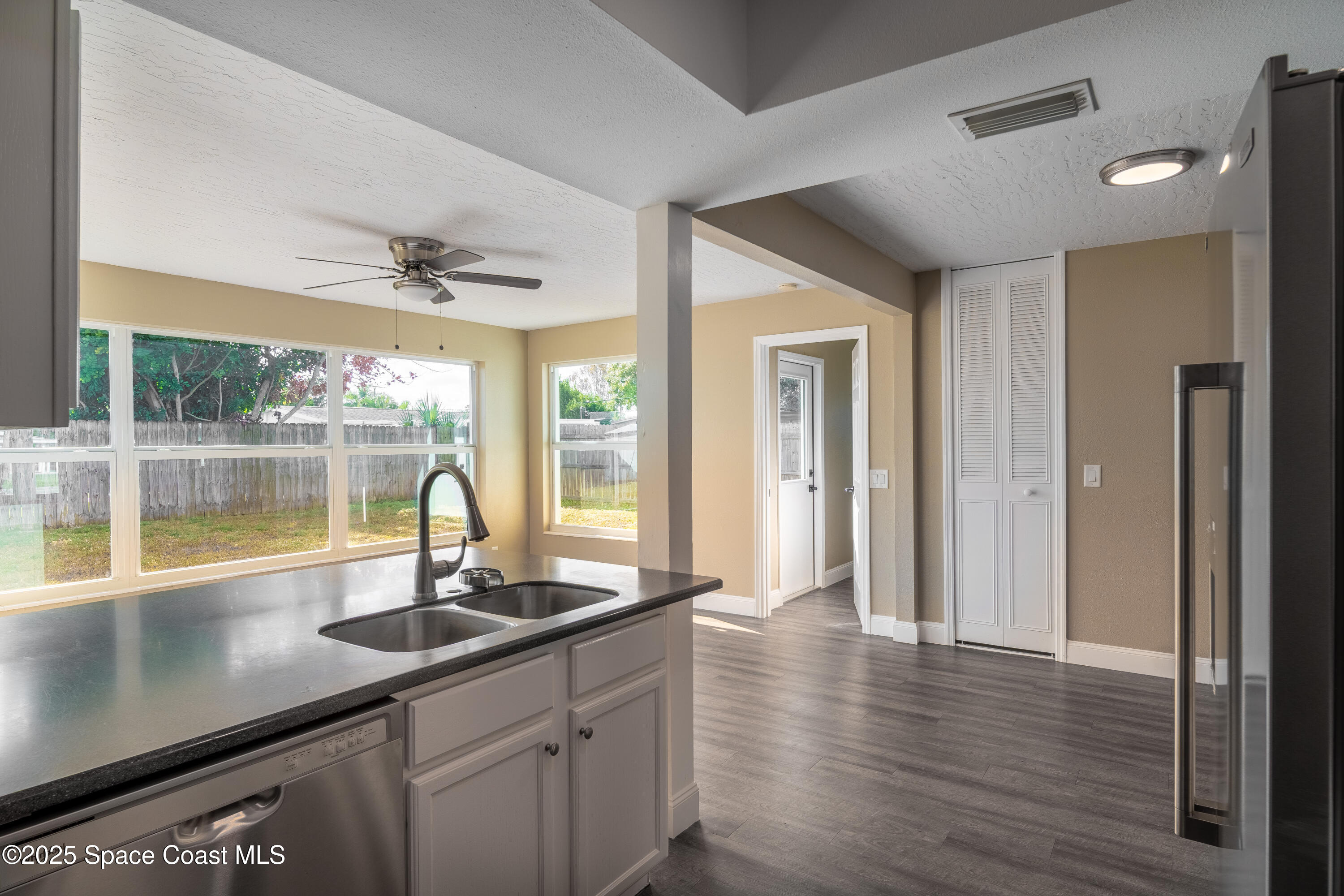 1705 Sarno Acc Melbourne, FL 32935 - Photo 35 of 40 a view of a sink window and wooden floor