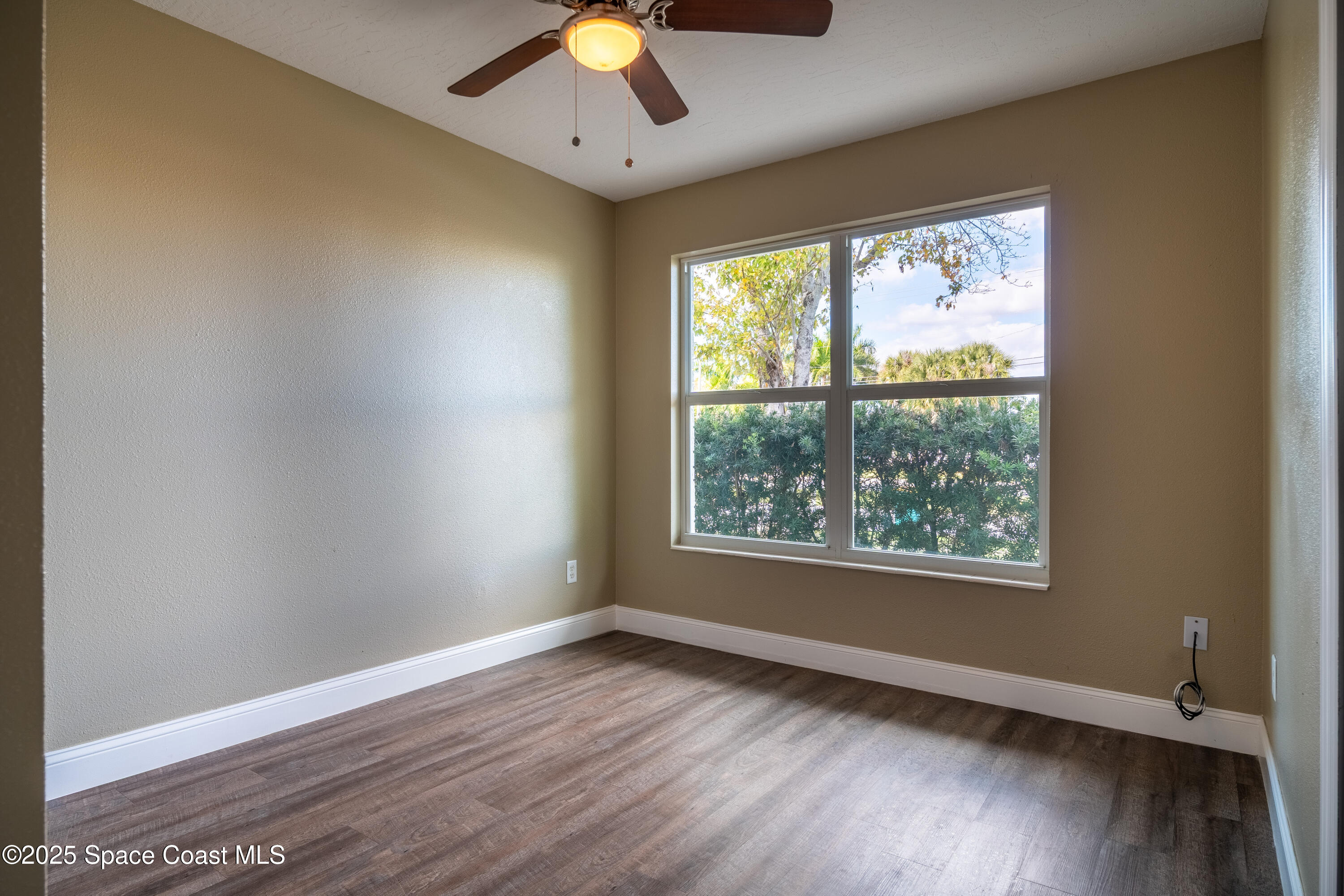 1705 Sarno Acc Melbourne, FL 32935 - Photo 39 of 40 an empty room with wooden floor and windows
