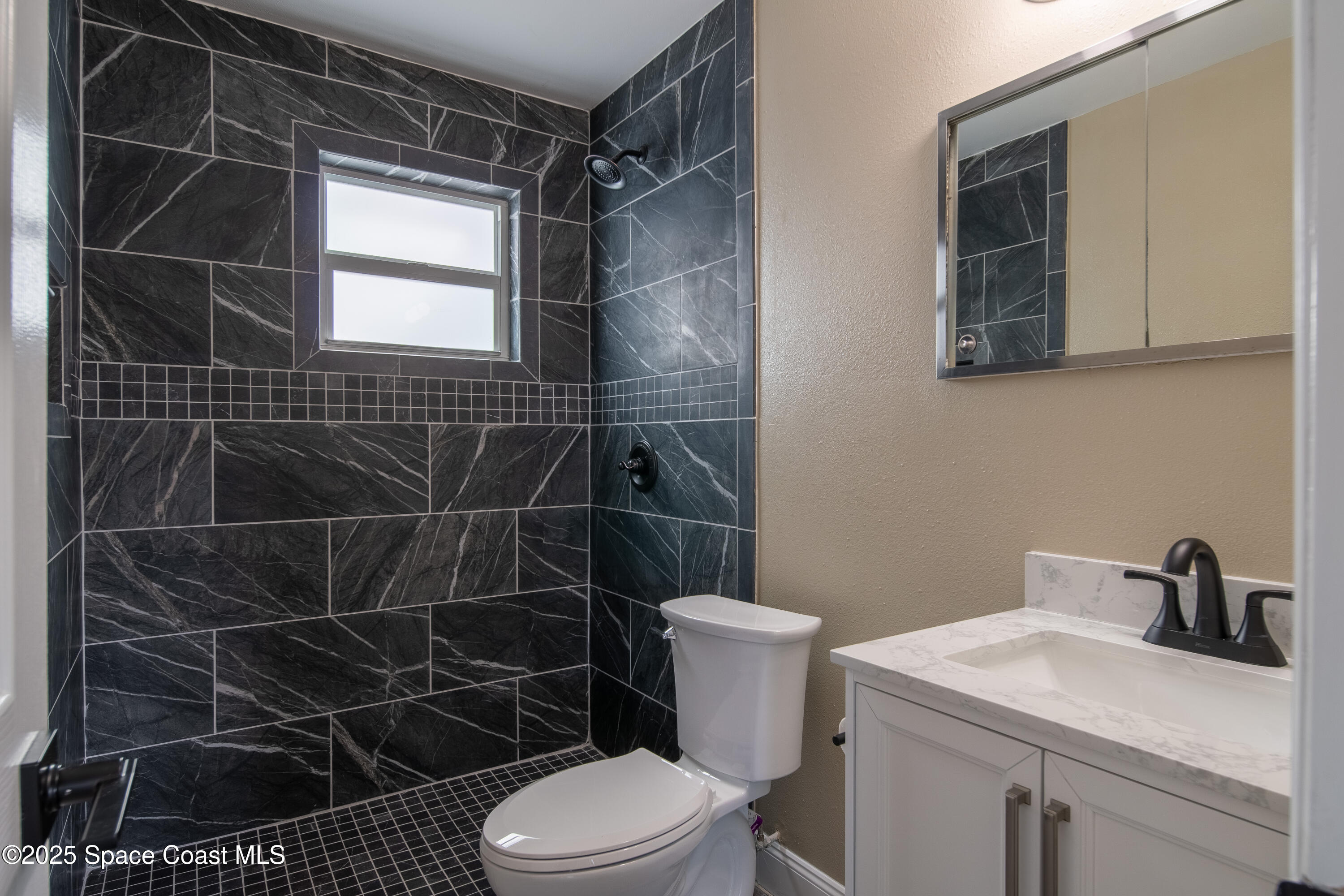 1705 Sarno Acc Melbourne, FL 32935 - Photo 40 of 40 a bathroom with a toilet a sink and a shower