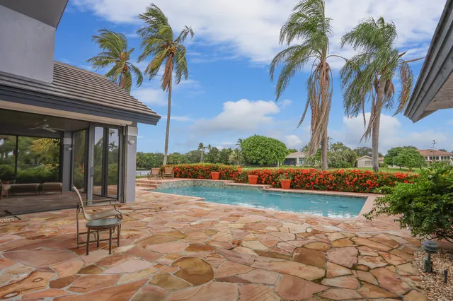 a view of a patio with a table and chairs under an umbrella