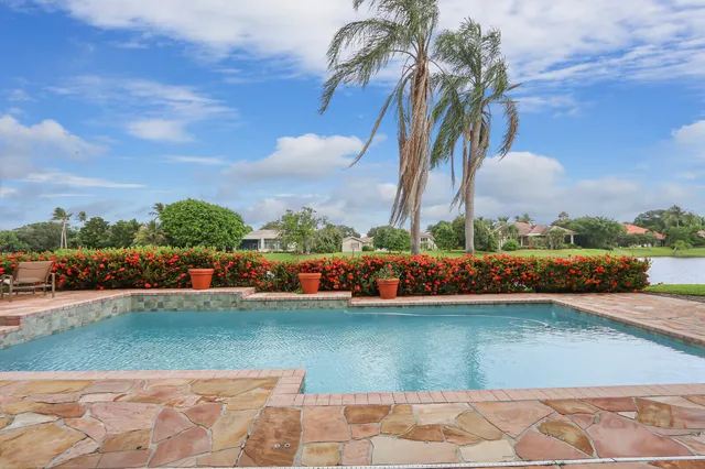 a view of a house with swimming pool and sitting area