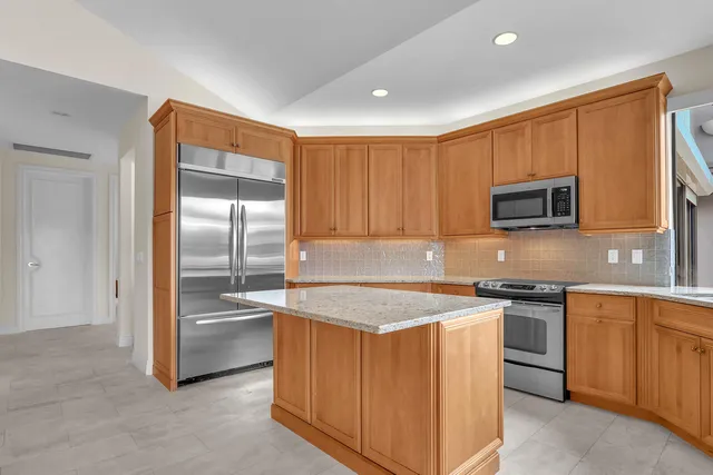 a kitchen with stainless steel appliances granite countertop a sink and cabinets