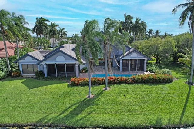 an aerial view of a houses with a swimming pool
