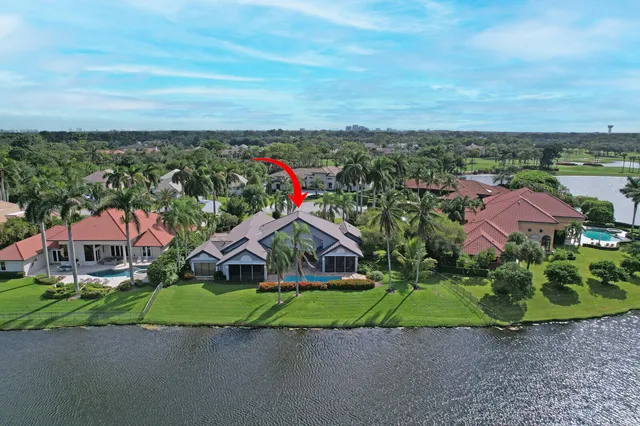 an aerial view of lake and residential houses with outdoor space