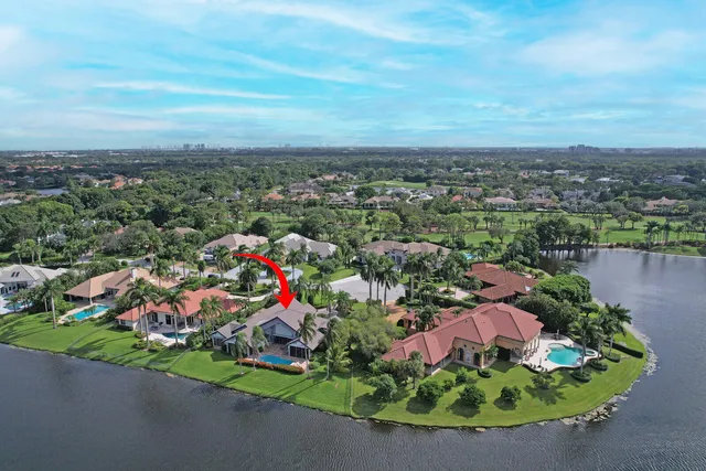 an aerial view of a houses with a lake