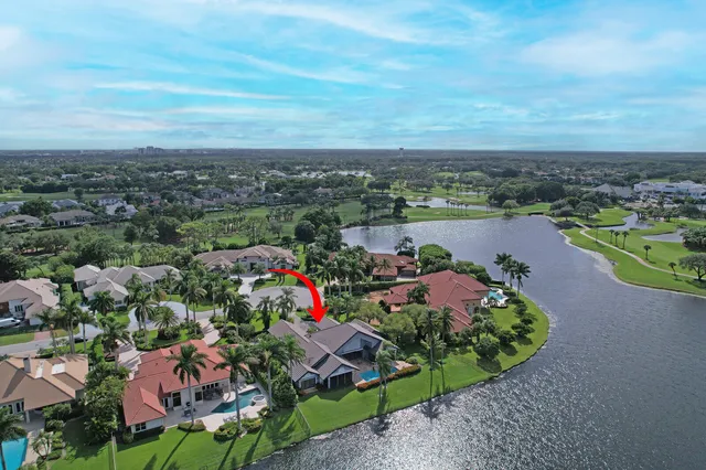 an aerial view of residential houses with outdoor space and lake view