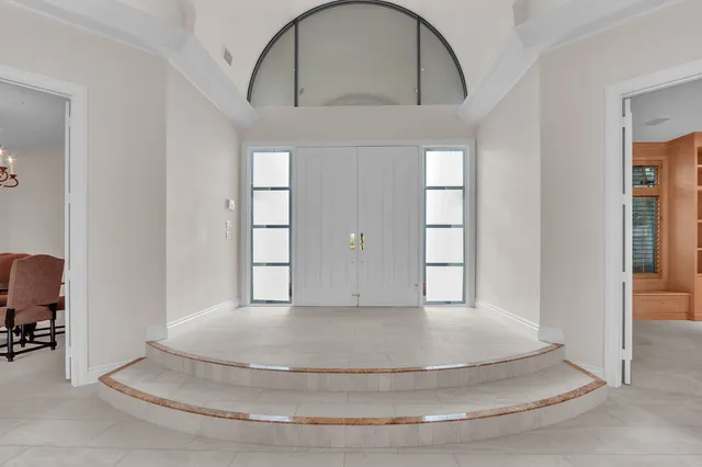 a spacious bathroom with a granite countertop sink mirror and a bathtub