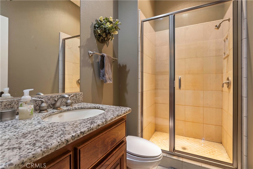 8664 Seigler Springs Road Kelseyville, CA 95451 - Photo 20 of 75 a bathroom with a granite countertop sink toilet and shower