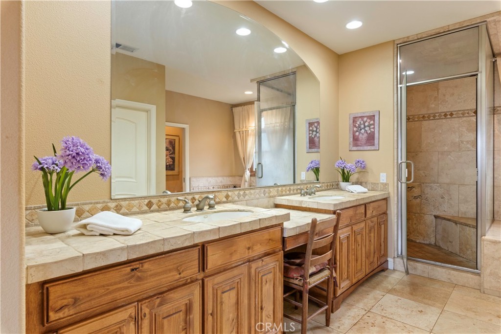 8664 Seigler Springs Road Kelseyville, CA 95451 - Photo 25 of 75 a bathroom with a granite countertop sink a mirror and a shower