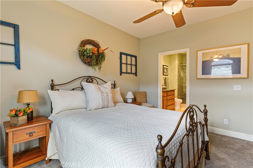 8664 Seigler Springs Road Kelseyville, CA 95451 - Photo 29 of 75 a bedroom with a bed and a chandelier