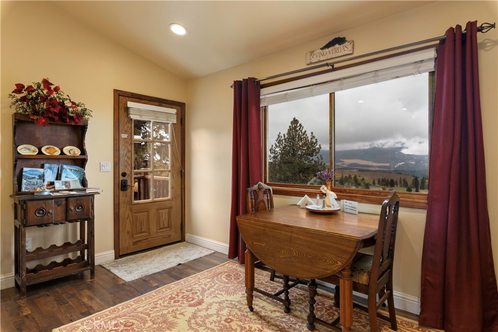 8664 Seigler Springs Road Kelseyville, CA 95451 - Photo 41 of 75 a view of a dining room with furniture window and wooden floor
