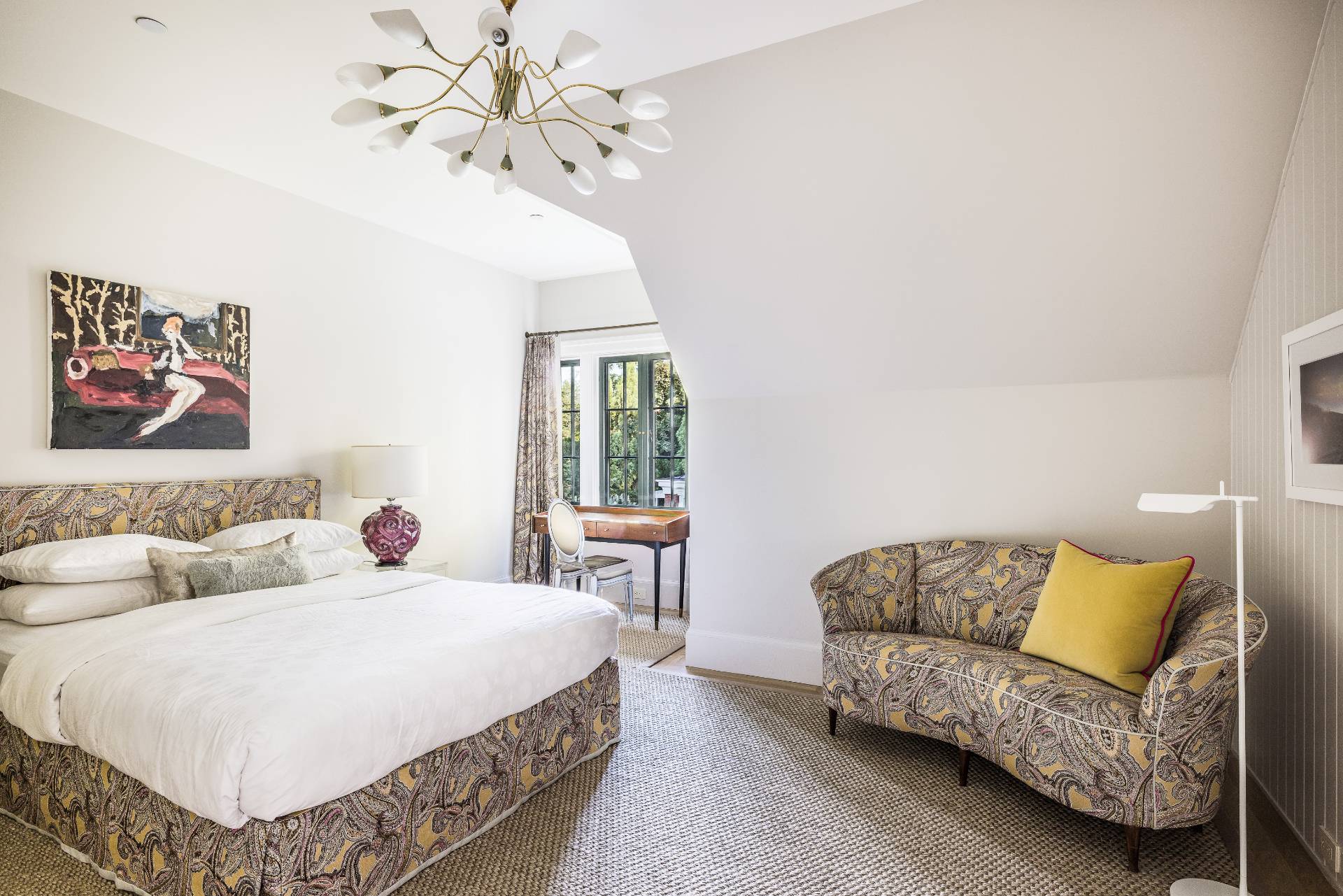 43 Lee Avenue East Hampton, NY 11937 - Photo 38 of 49 a spacious bedroom with a bed a couch and a chandelier