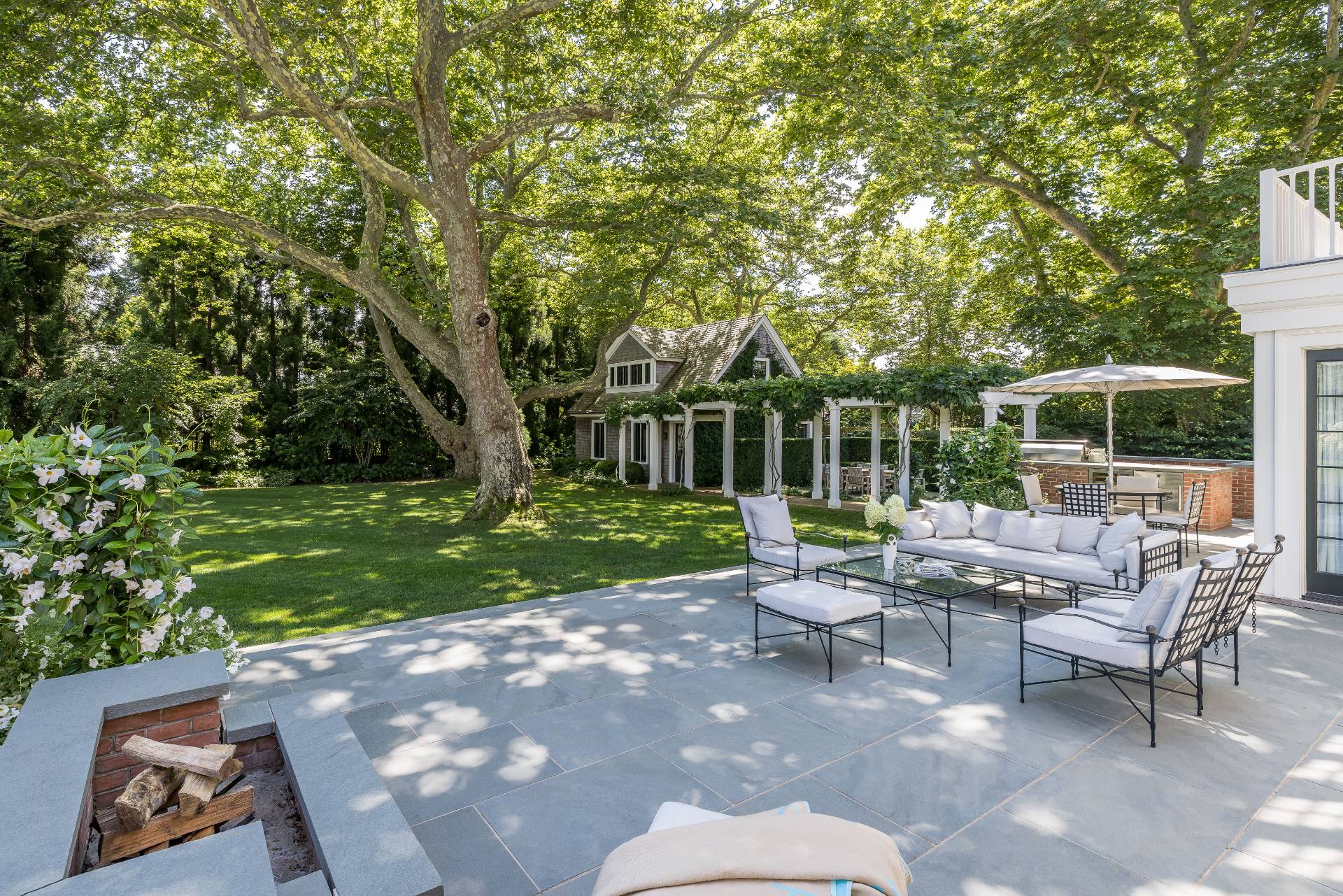 43 Lee Avenue East Hampton, NY 11937 - Photo 8 of 49 a view of a chair and tables in the garden
