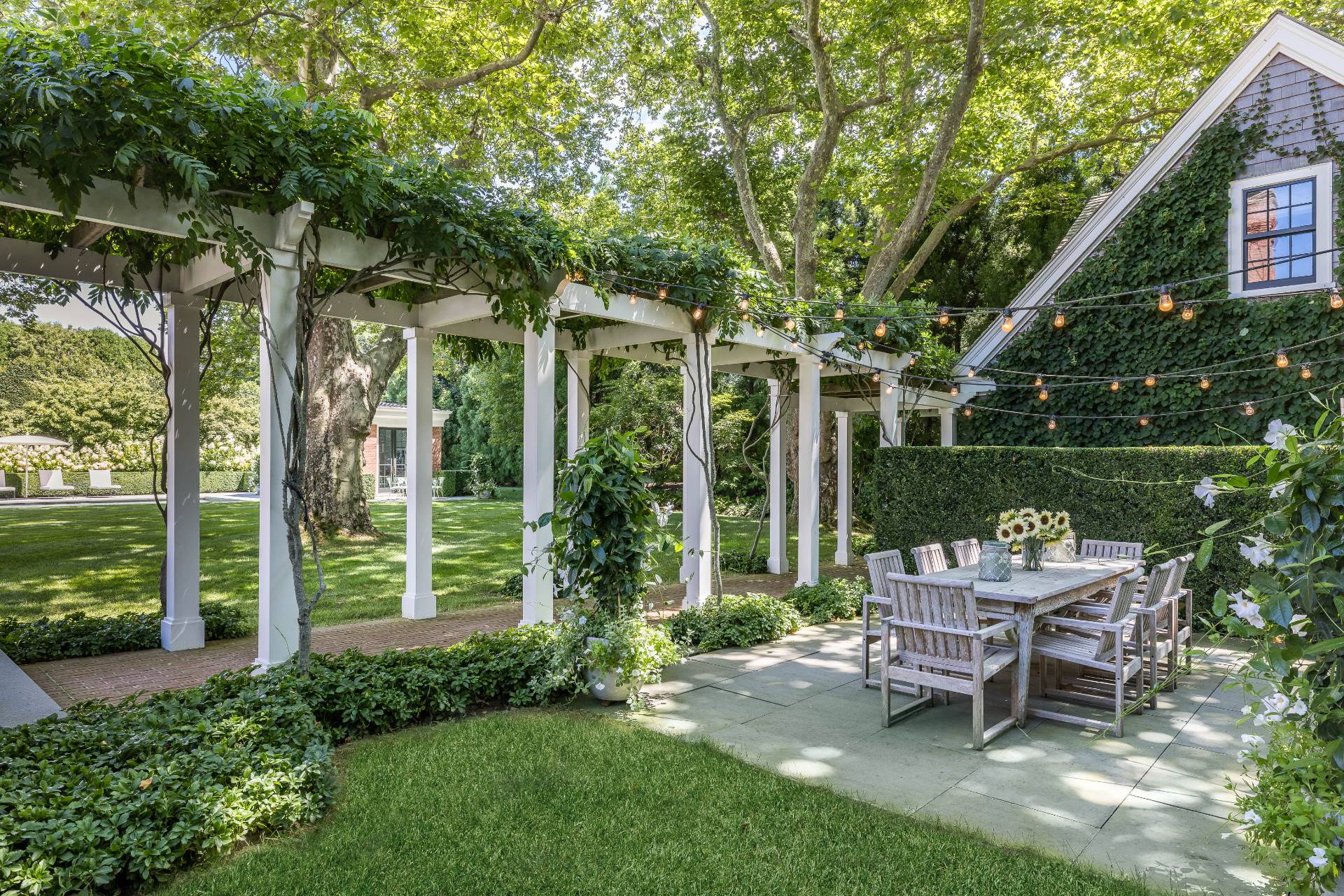 43 Lee Avenue East Hampton, NY 11937 - Photo 10 of 49 a chair and table sitting in backyard of house