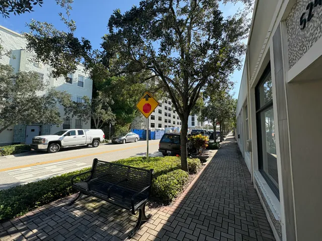 a view of a patio with couches table and chairs and potted plants