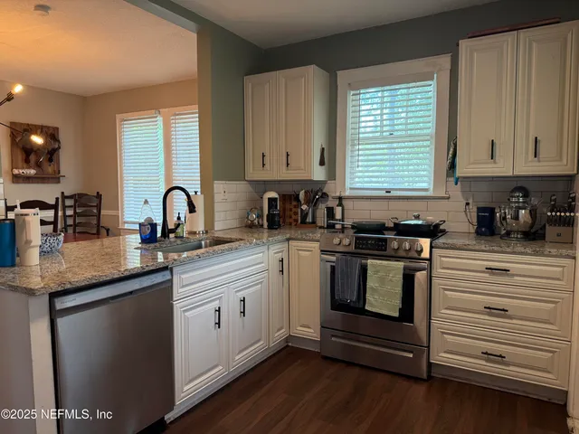 a kitchen with a sink stove and cabinets