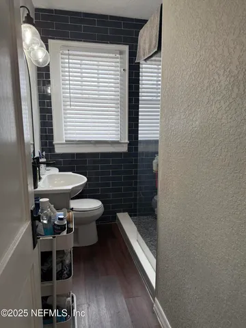 a bedroom with a bed and a view of en suite bathroom