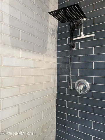 a view of walk in closet with clothes