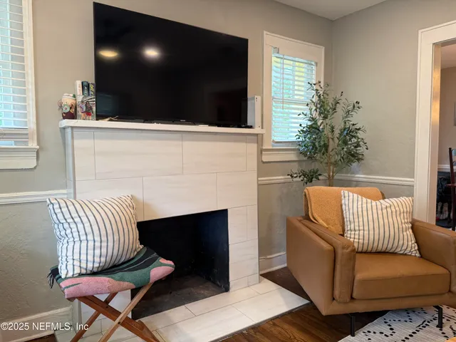 a living room with furniture and a potted plant