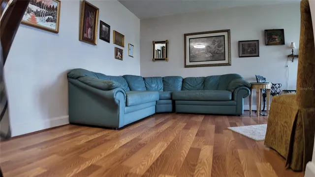 a view of a livingroom with furniture and natural light