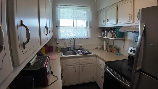 a kitchen with a sink appliances and cabinets
